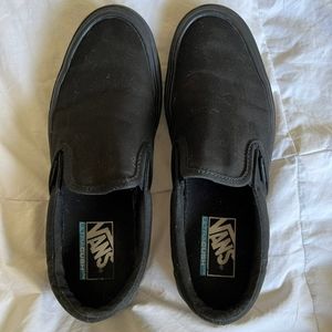 All black slip on vans